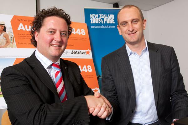 Justin Watson, General Manager Marketing and Communications, Tourism New Zealand (left) and Bruce Buchanan, CEO, Jetstar Group (right) shake on $9million partnership.